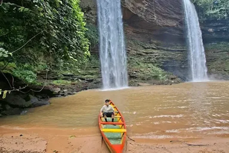 Boti Falls twin cascades with canoe, Eastern Region